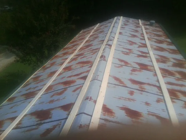 Rusted metal roof panels with new wood purlins before replacement — Storm Damage Roof Repair in Waldorf by Roofing Brothers